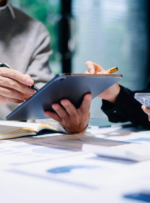 Business team collaboration discussing working analyzing with financial data and marketing growth report graph in team, presentation and digital tablet, laptop. in office